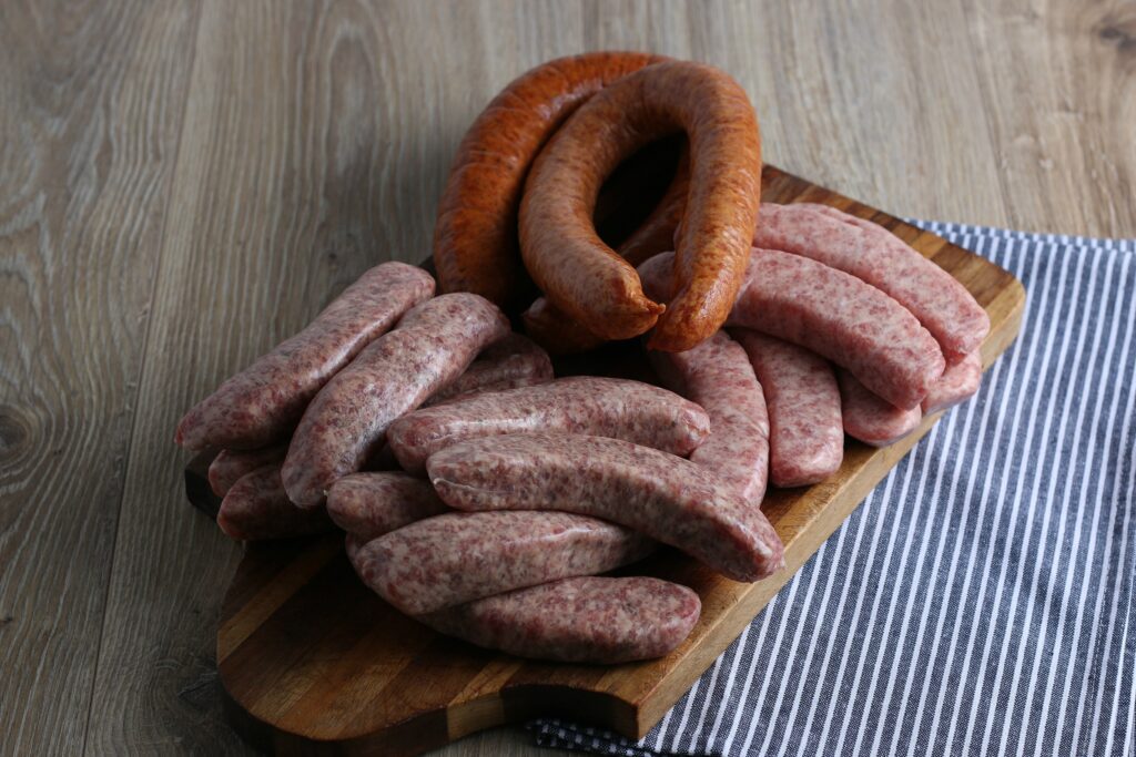 raw italian sausage on cutting board