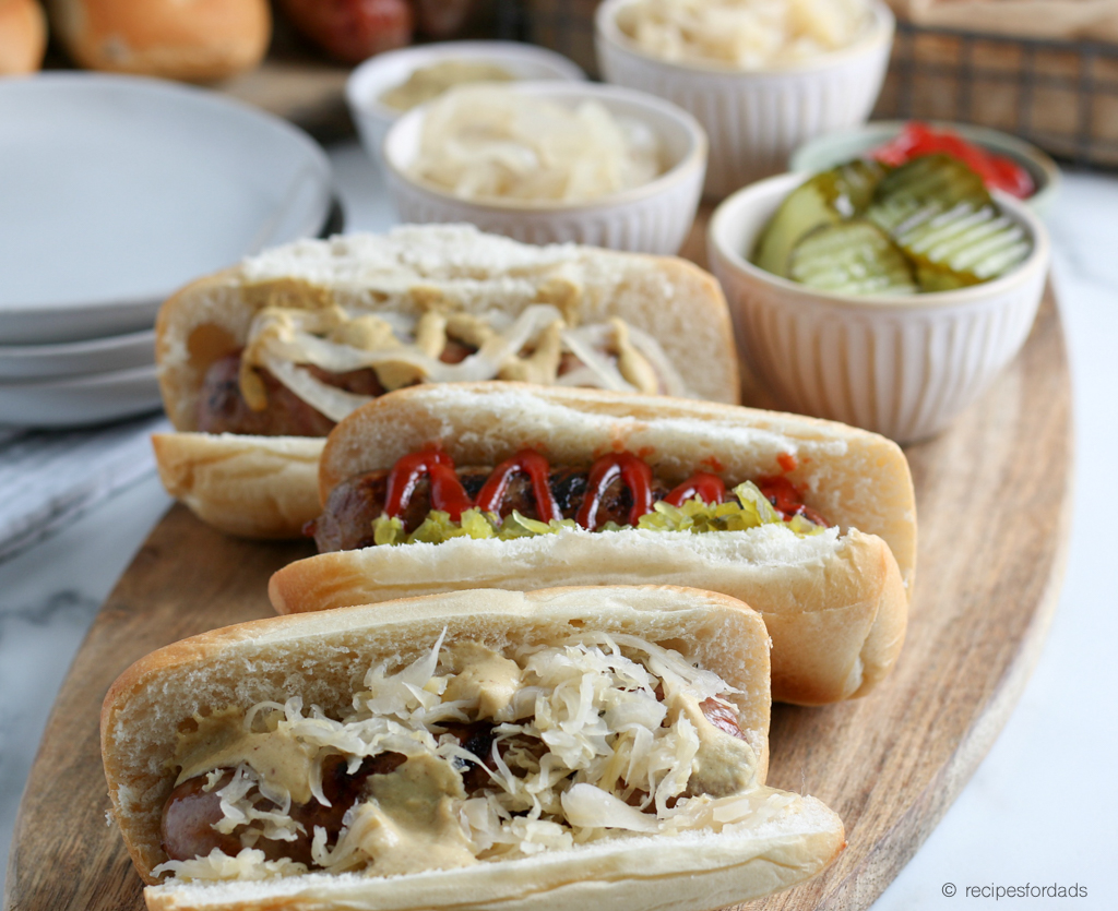 Beer Brats served with sauerkraut and mustard, with a red and white checkered napkin