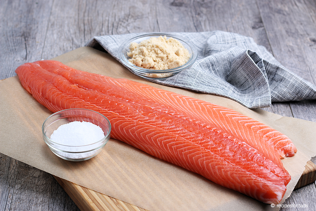 Preparing wild salmon with salt and brown sugar for the smoker, served on white board and napkin