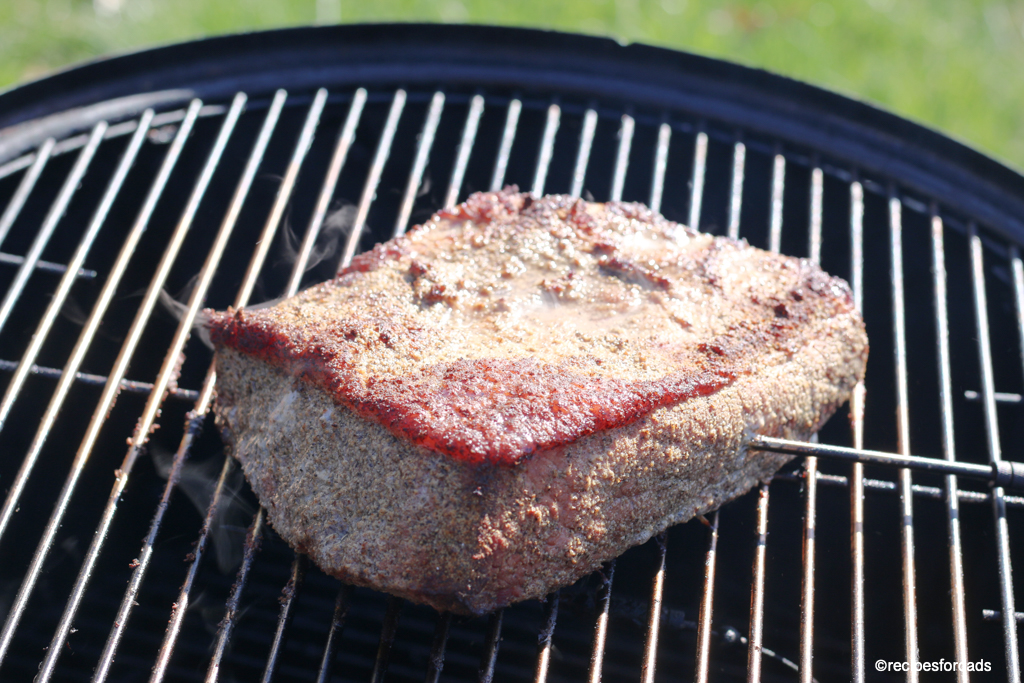smoked corned beef brisket cooking on smoker
