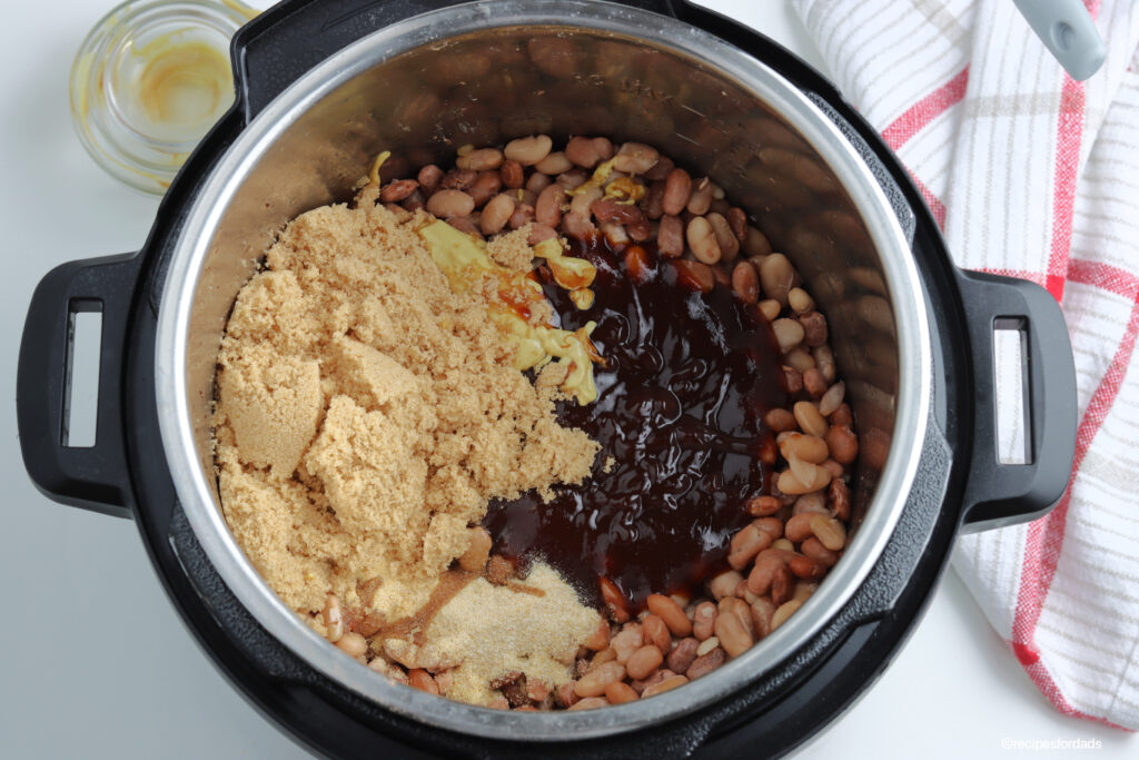 ingredients mixed together to make bbq baked beans in a pressure cooker