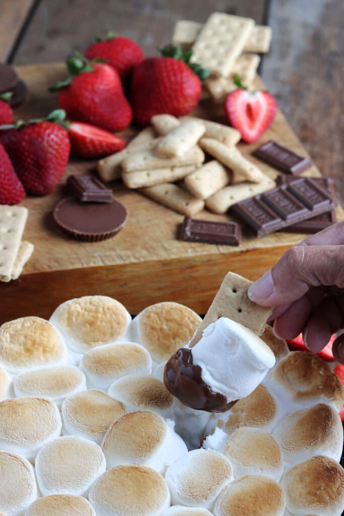 dipping graham cracker in the S'mores Dip