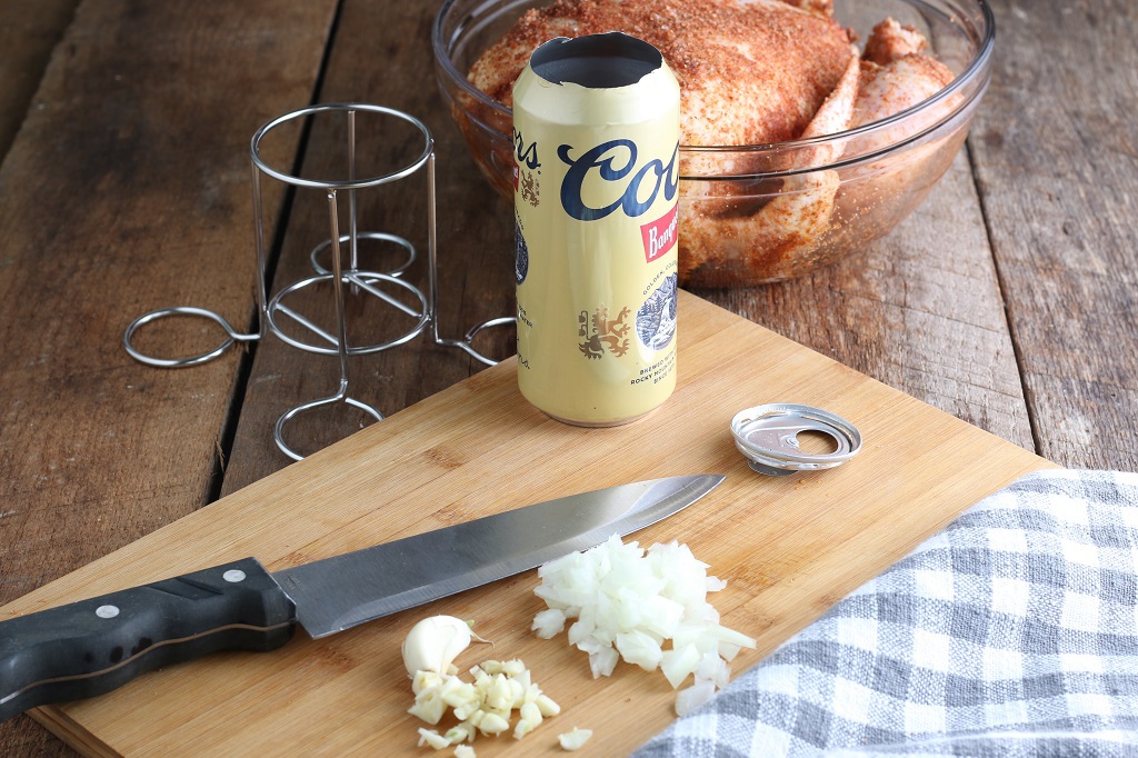 Chopped onion, chicken beer stand and whole chicken