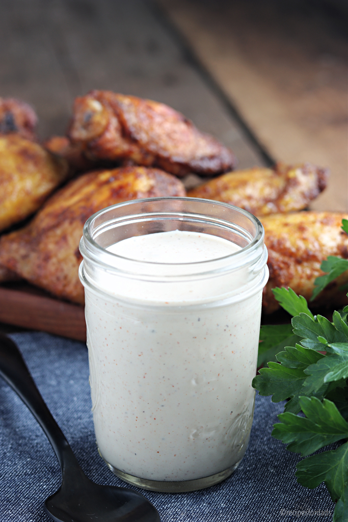 Alabama White Sauce in jar served with chicken thighs