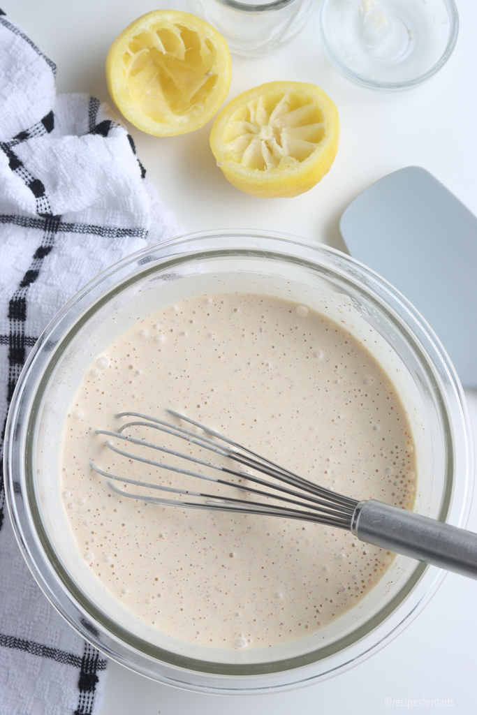 Whisking the ingredients together of the Alabama White Sauce.