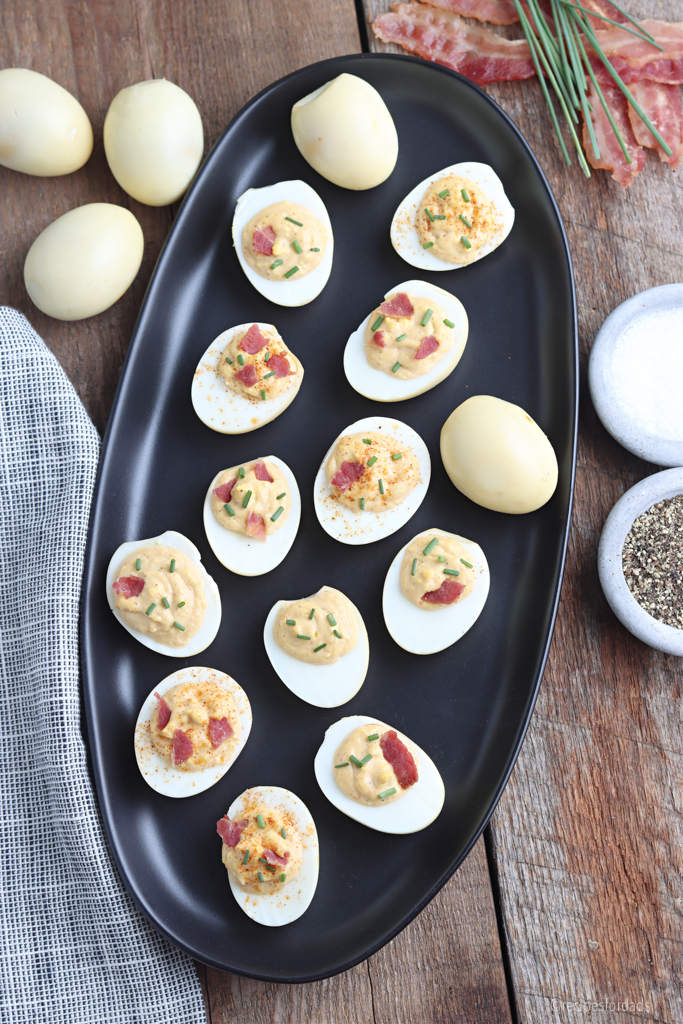 smoked deviled eggs recipe on black serving plate