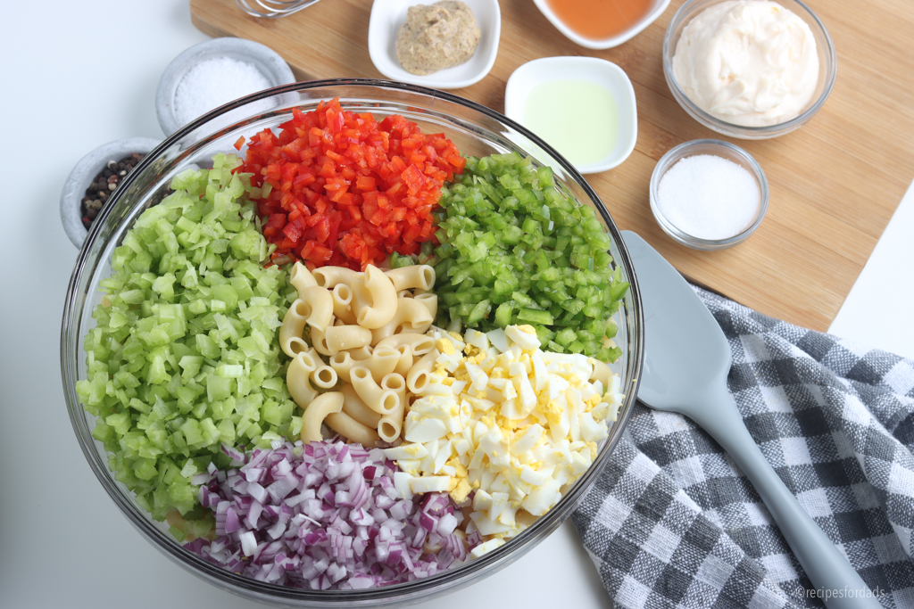 Vegetables, eggs, and pasta for macaroni salad.