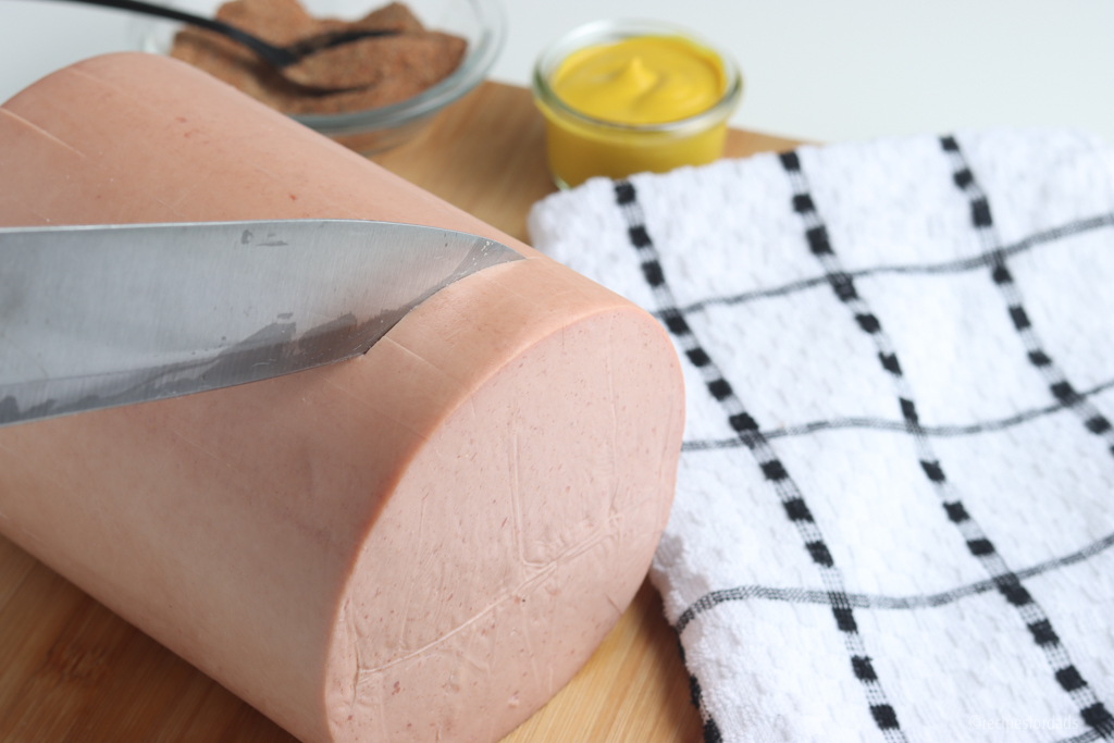 Cutting bologna in a crisscross pattern.