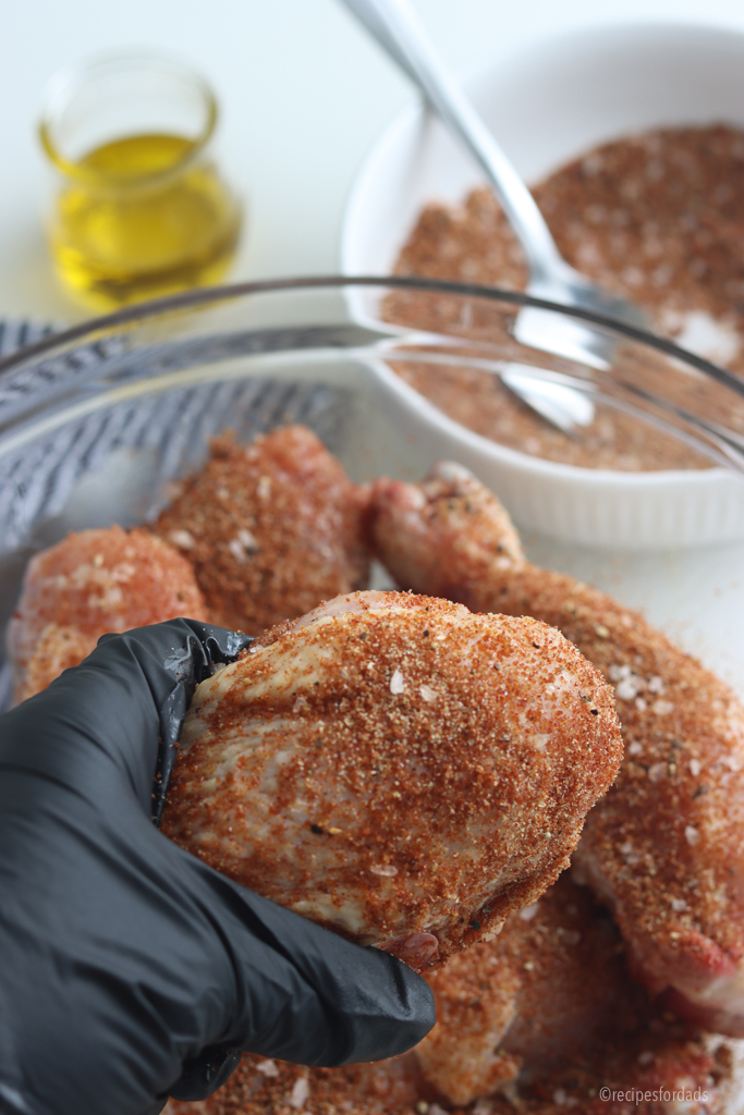 Rubbing seasonings onto drumsticks