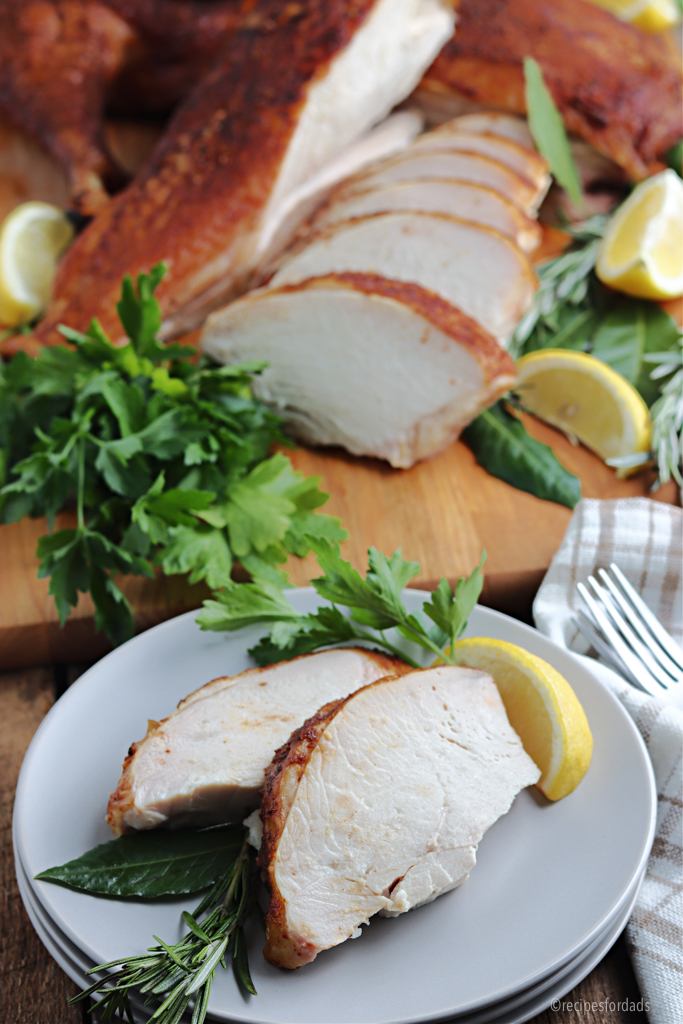 smoked spatchcock turkey cut and served on gray plate