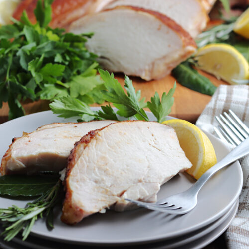 smoked spatchcock turkey cut and served on gray plate