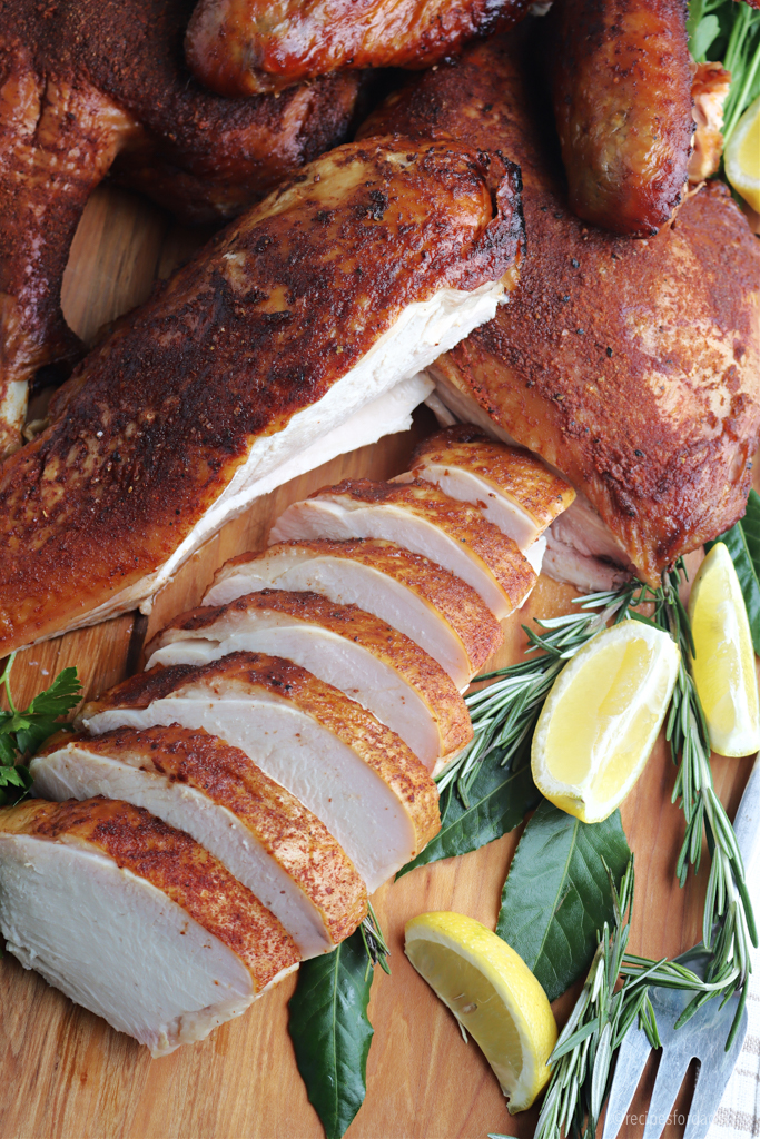smoked spatchcock turkey cut and served on cutting board