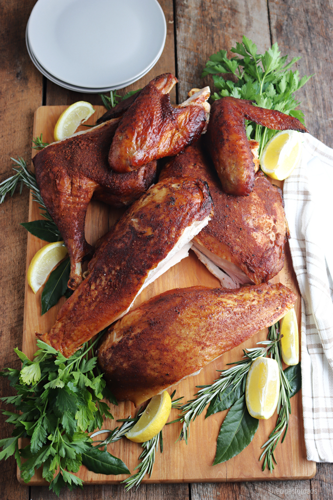 smoked spatchcock turkey cut and served on cutting board