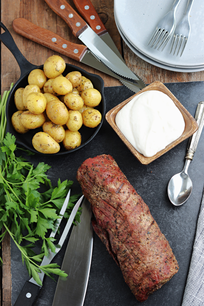 smoked beef tenderloin sliced and served on board