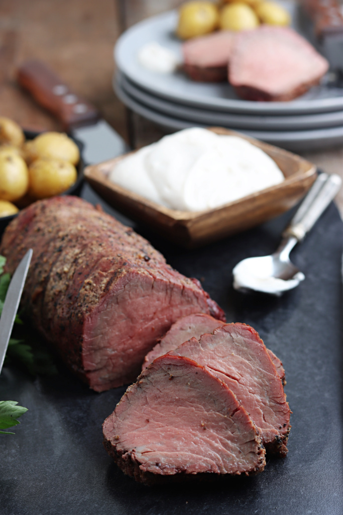 smoked beef tenderloin sliced and served on board