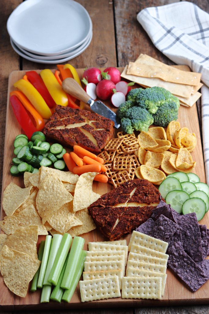 Charcuterie board with vegetables and chips