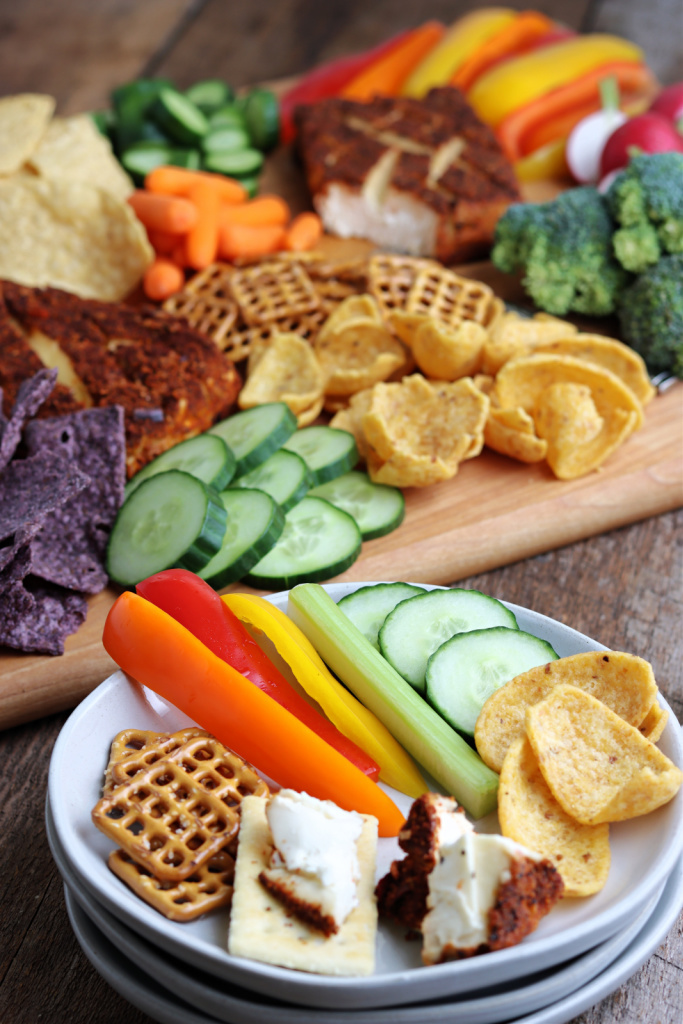 smoked cream cheese on a plate with vegetables and pretzels