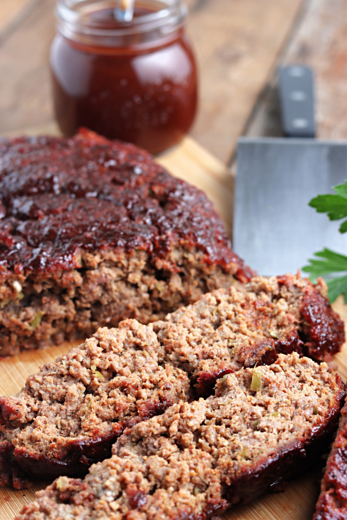 smoked meatloaf on cutting board with barbecue sauce