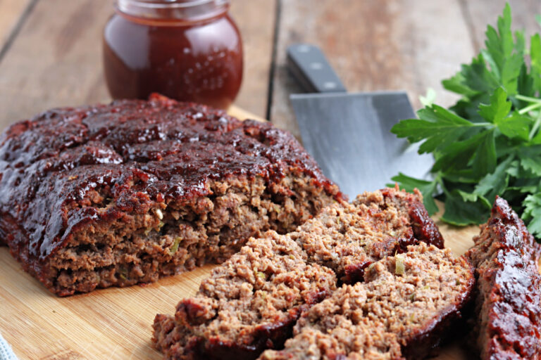 smoked meatloaf on cutting board with barbecue sauce