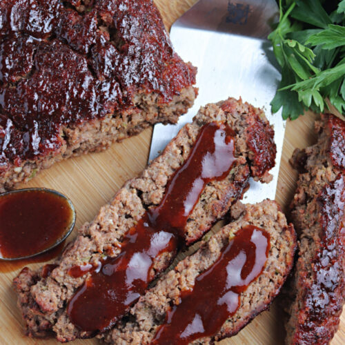 smoked meatloaf on cutting board with barbecue sauce