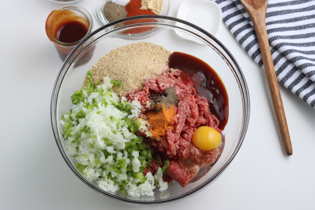 ingredients for smoked meatloaf in a glass bowl