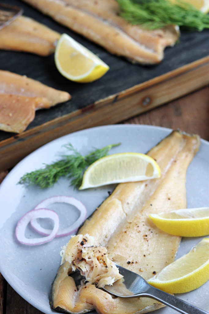 smoked rainbow trout on gray plate with fork