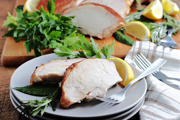 smoked spatchcock turkey cut and served on gray plate