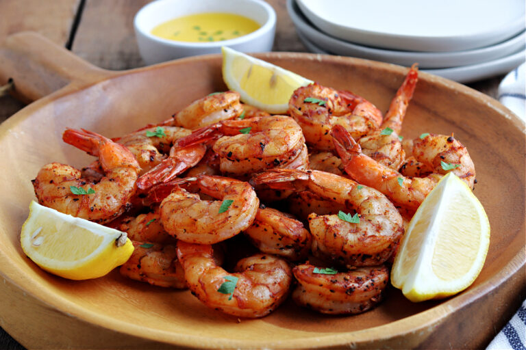 smoked shrimp in wood bowl with parsley and lemon wedges