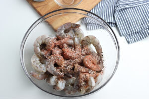 shrimp with seasoning in clear glass bowl