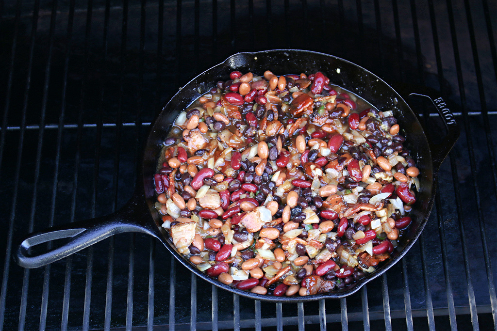 smoked baked beans in cast iron skillet on Traeger Smoker