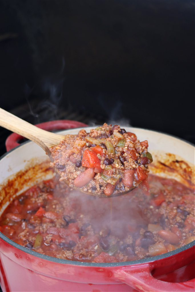 wooden spoon of smoked chili on Traeger smoker
